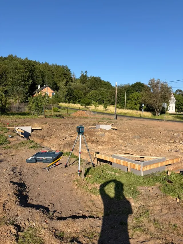 Začínáme s výškami a polohou pásů. Laser u výkopu pomáhá převést projekt do terénu.