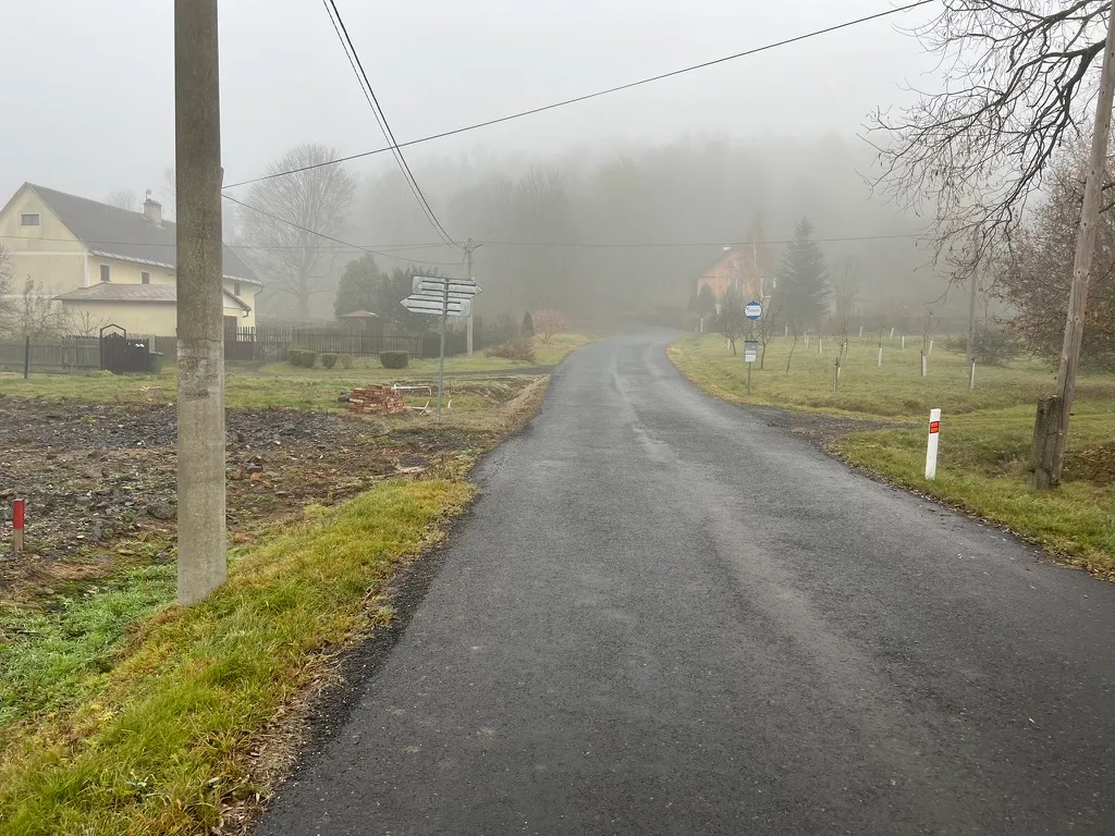 Cesta kolem pozemku mizí v mlze. Přesně tak zatím vypadá i naše cesta k novému domu — směr známe, konec ne.