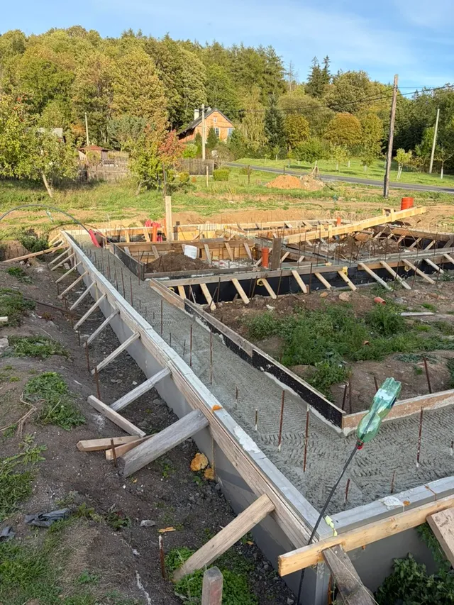Beton v rohu pásů, kolem stále stojí celé šalování.